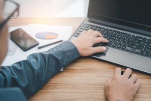 business-man-use-mouse-computer-to-point-in-laptop-monitor-and-thinking-about-planning-a-work-use-laptop-computer-working-on-the-deck-free-photo